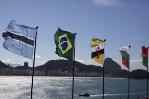 A Brazilian Navy boat patrols the Copacabana beach as national flags flutter on the Copacabana Fort