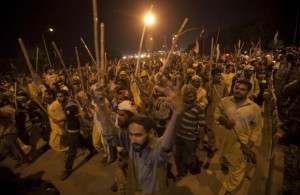 Supporters of ul-Qadri carry sticks as they move towards the Prime Minister's house during the Revolution March in Islamabad